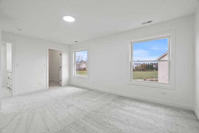 carpeted empty room with plenty of natural light