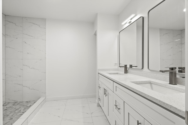 bathroom with tiled shower and vanity