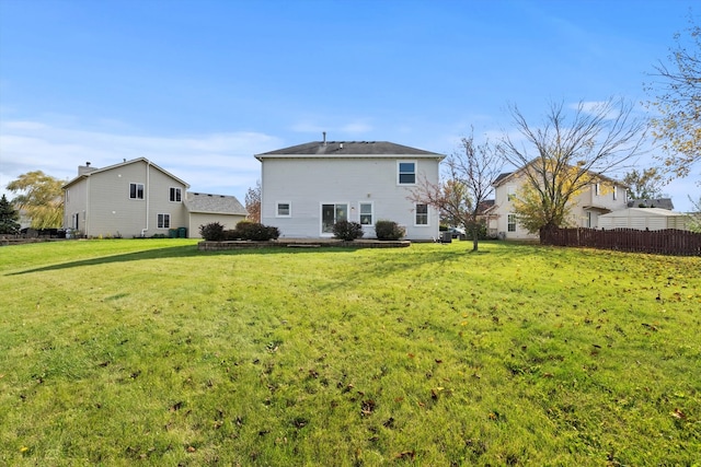 back of property featuring a lawn