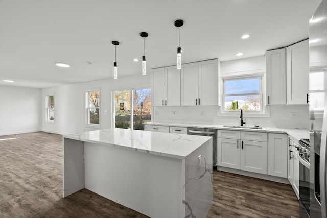 kitchen featuring sink, white cabinets, dark wood-type flooring, and a kitchen island