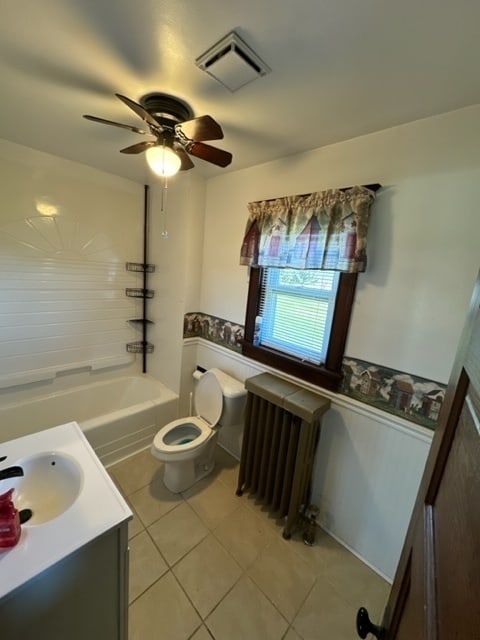 full bathroom featuring vanity, tile patterned flooring, ceiling fan, toilet, and radiator heating unit