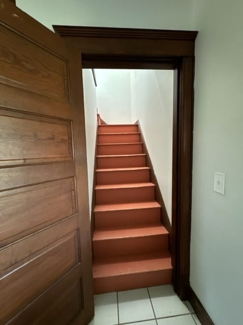 stairway with tile patterned flooring