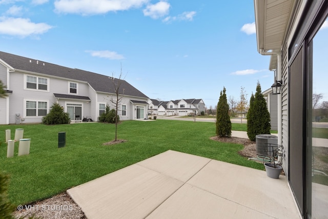 view of yard featuring central AC and a patio area