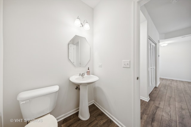 bathroom with hardwood / wood-style floors and toilet