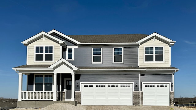 view of front of home featuring covered porch and a garage