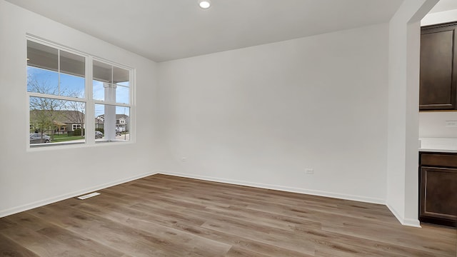 spare room featuring light hardwood / wood-style floors