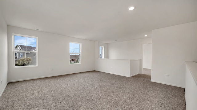 carpeted spare room featuring a wealth of natural light