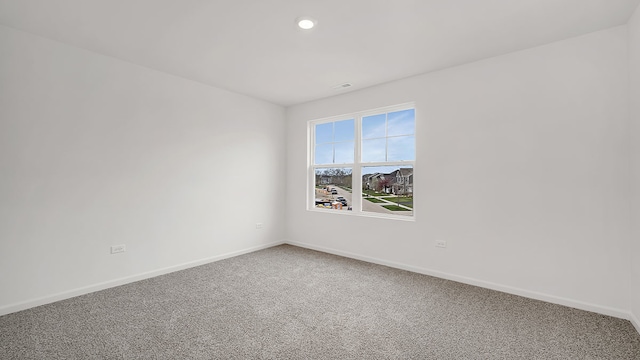 unfurnished room featuring carpet