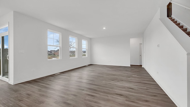 unfurnished living room featuring dark hardwood / wood-style flooring