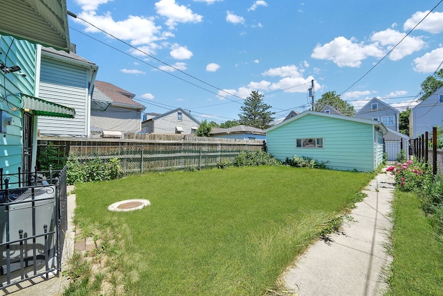 view of yard featuring an outdoor structure and a fire pit