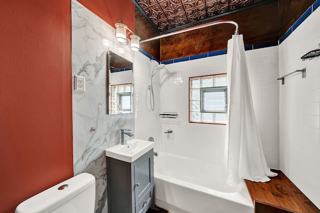 full bathroom with vanity, shower / bath combination with curtain, and toilet