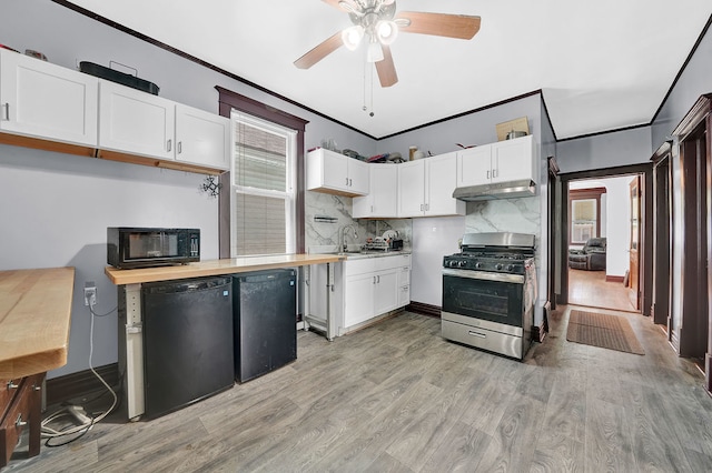 kitchen with light hardwood / wood-style flooring, white cabinetry, ornamental molding, and black appliances