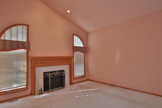 unfurnished living room featuring a fireplace, light colored carpet, and high vaulted ceiling