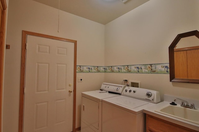 clothes washing area featuring washer and dryer, cabinets, and sink