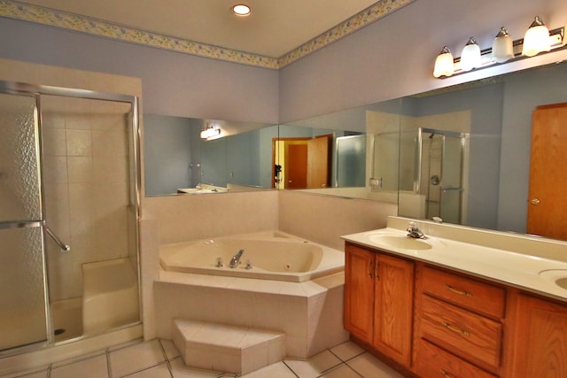 bathroom with plus walk in shower, tile patterned flooring, and vanity