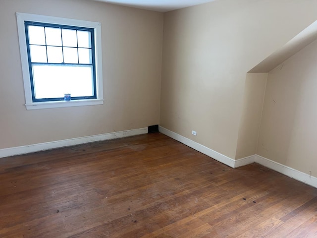 additional living space featuring dark hardwood / wood-style floors