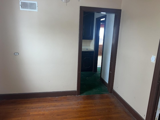 hallway with dark hardwood / wood-style flooring