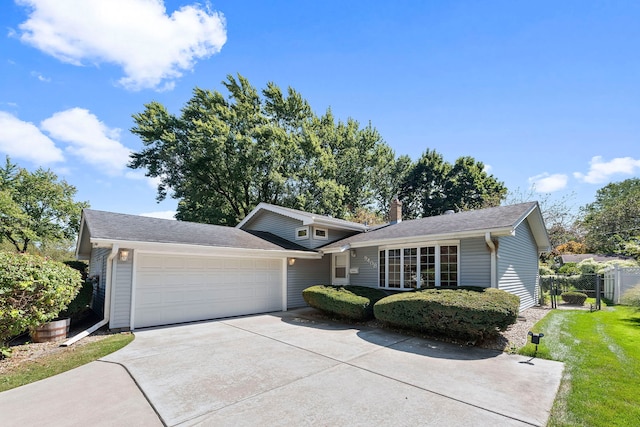 view of front of home with a front lawn and a garage