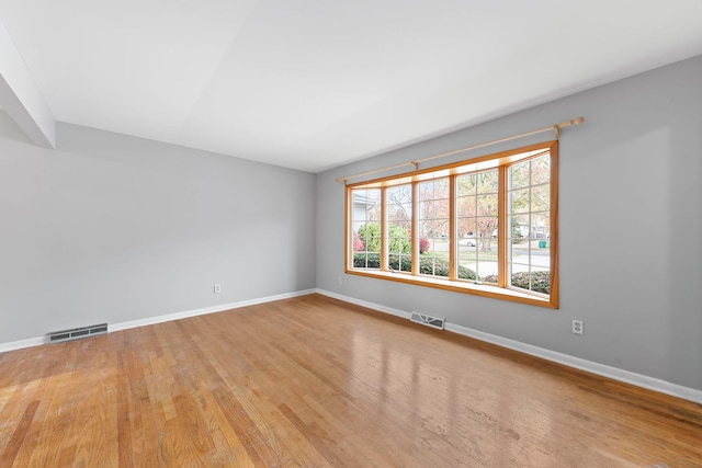 unfurnished room with light wood-type flooring