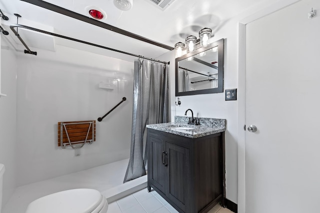 bathroom with tile patterned floors, toilet, vanity, and a shower with shower curtain