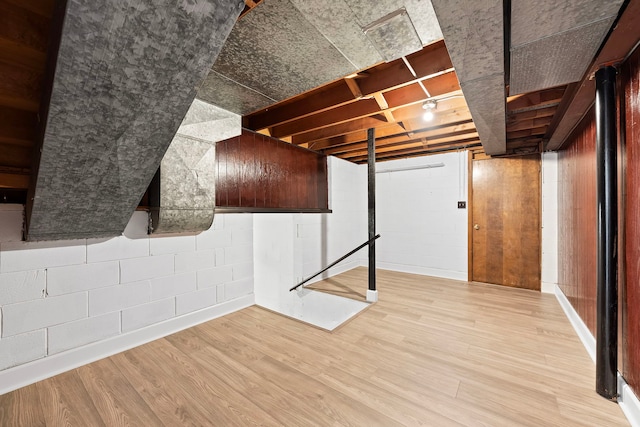 basement with light hardwood / wood-style flooring