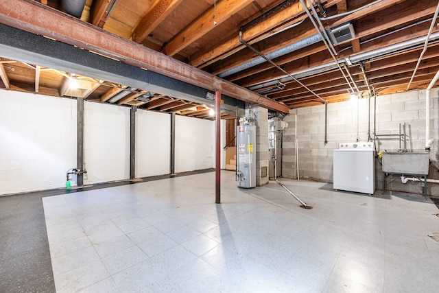 basement with washer / dryer, sink, and water heater