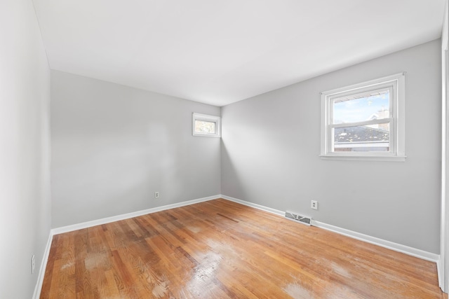 spare room with light hardwood / wood-style flooring and plenty of natural light