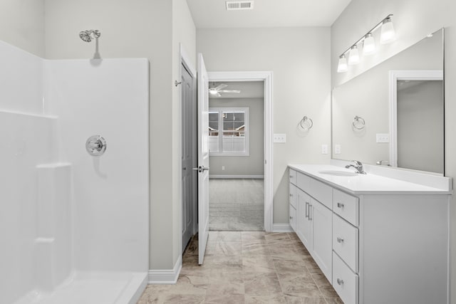 bathroom featuring vanity, ceiling fan, and walk in shower