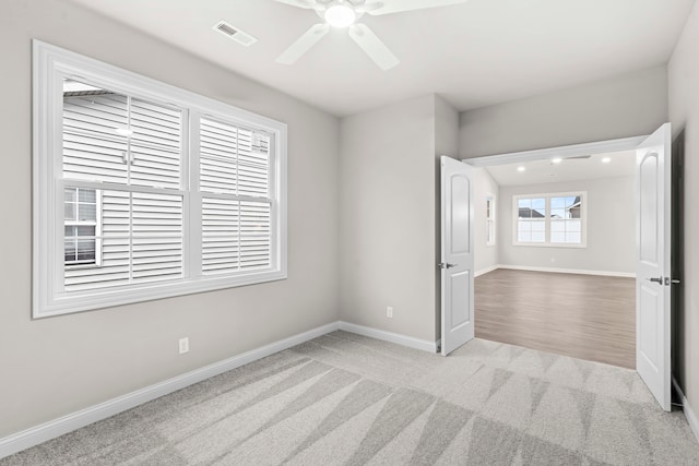 carpeted empty room with ceiling fan