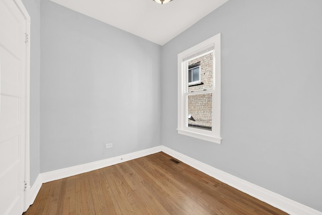 spare room with hardwood / wood-style floors