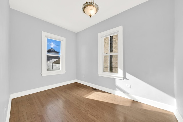 empty room with dark hardwood / wood-style floors