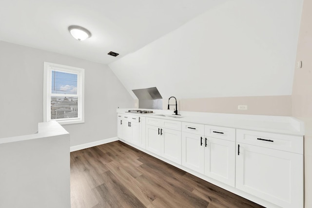 interior space with dark hardwood / wood-style flooring and sink