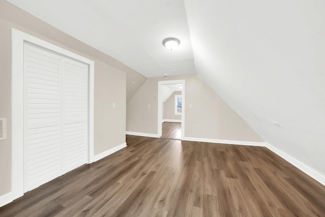 bonus room featuring dark hardwood / wood-style flooring and vaulted ceiling