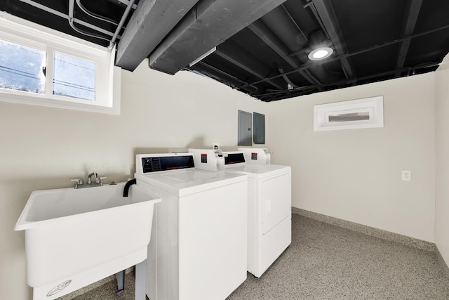 laundry area with washer and dryer, electric panel, and sink