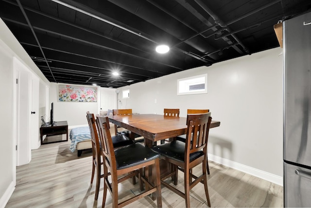 dining space with light hardwood / wood-style flooring