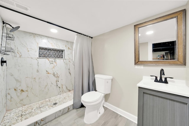 bathroom featuring vanity, toilet, a shower with shower curtain, and hardwood / wood-style flooring