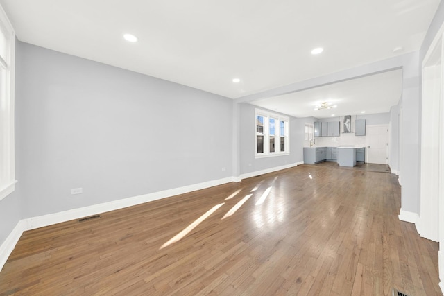 unfurnished living room featuring light wood-type flooring