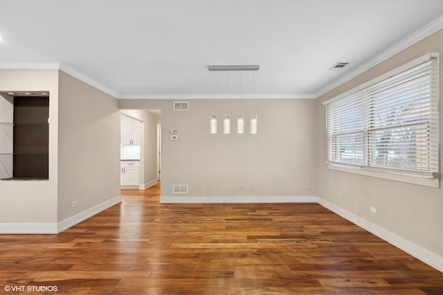 unfurnished room featuring hardwood / wood-style floors and ornamental molding