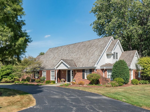 new england style home with a front yard