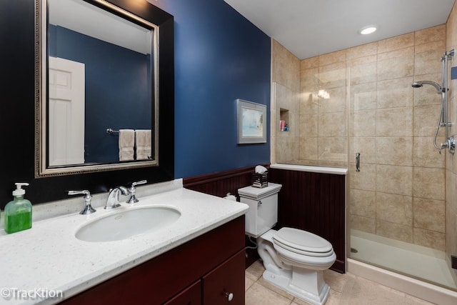 bathroom with toilet, vanity, tile patterned floors, and a shower with door