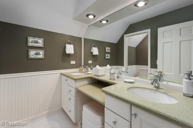 bathroom featuring vanity, tile patterned floors, and lofted ceiling