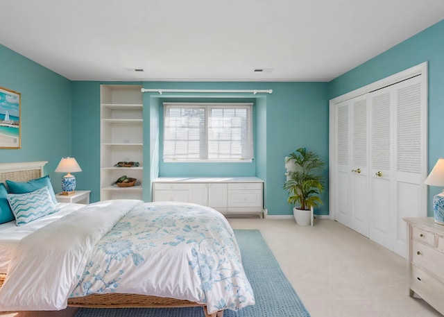 bedroom featuring light colored carpet and a closet