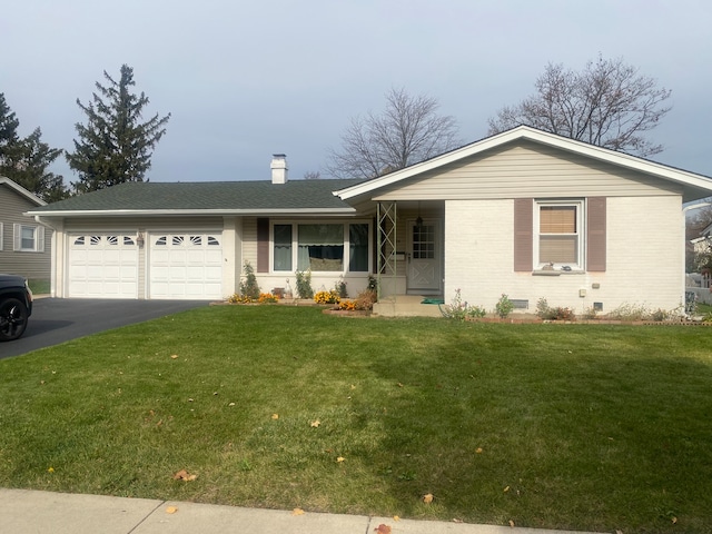 ranch-style home featuring a front lawn and a garage