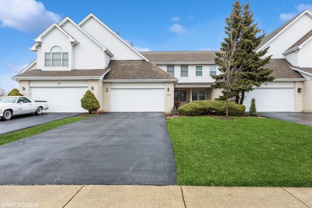 front facade featuring a garage and a front lawn