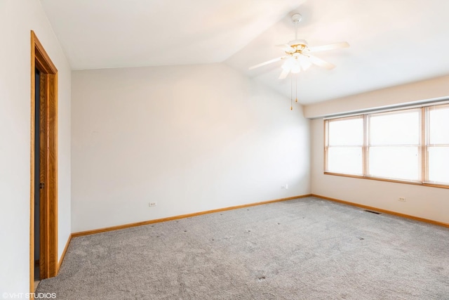 carpeted empty room with ceiling fan and lofted ceiling