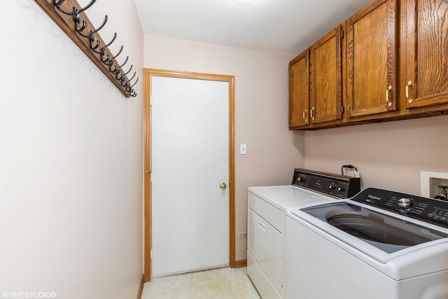 laundry area featuring cabinets and washing machine and dryer