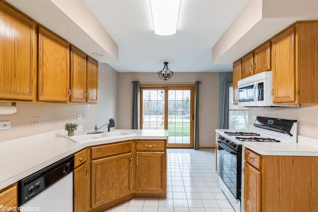 kitchen featuring kitchen peninsula, sink, light tile patterned floors, and white appliances