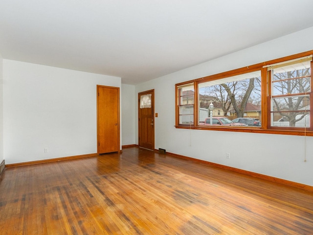 unfurnished room with wood-type flooring