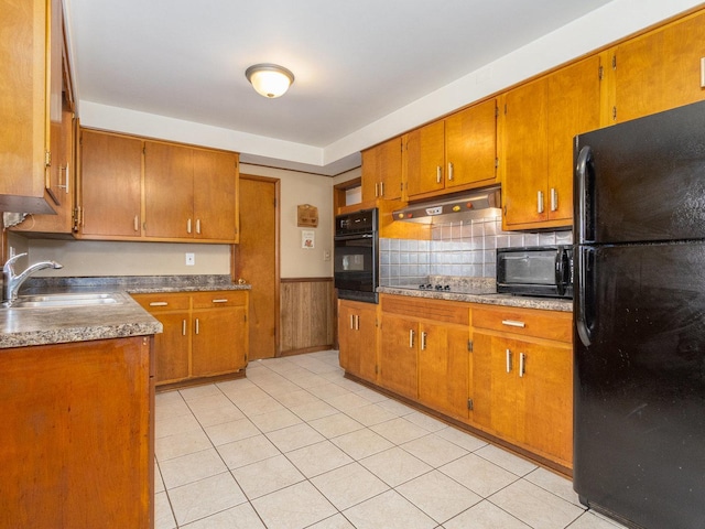 kitchen featuring sink, light tile patterned floors, and black appliances