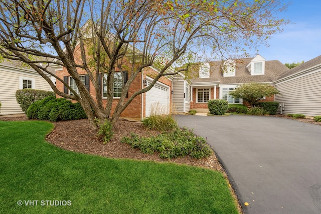 view of front of house featuring a front yard and a garage